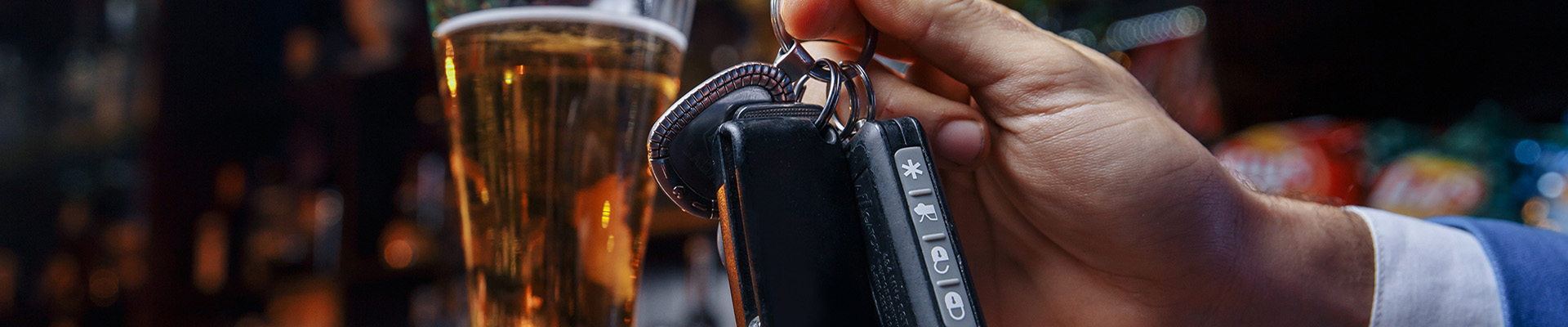 Keys in front of beer glass on a bar